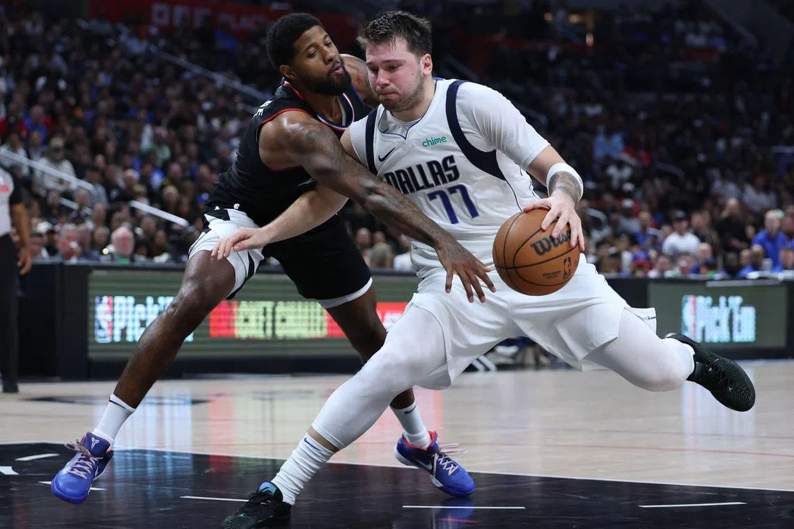 Luka Doncic of the Dallas Mavericks drives to the basket on Paul George of the LA Clippers at Crypto.com Arena in Game 2 of their NBA Western Conference play-offs.
