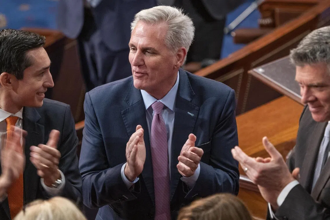 House Republican Leader Kevin McCarthy (centre) applauds a colleague who voted for him for the first time, in the House chamber, on Jan 6, 2022. .