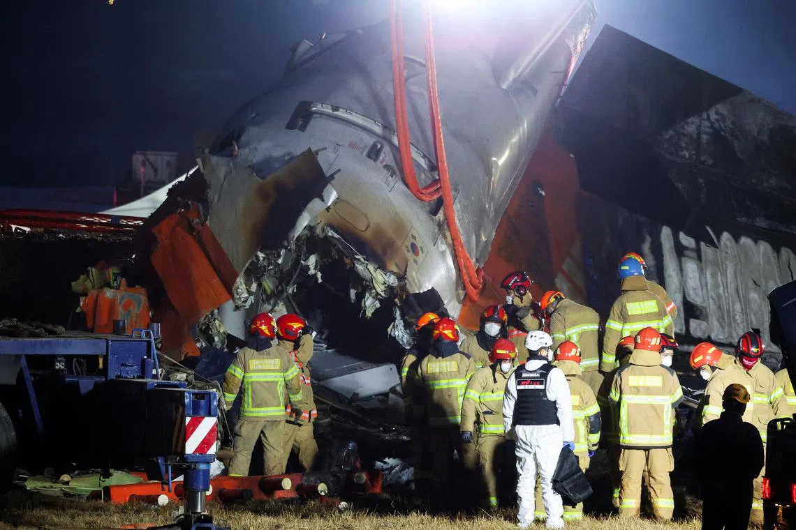 Rescuers work the wreckage of an aircraft that went off the runway and crashed, at Muan International Airport, in Muan, South Korea, December 29, 2024. REUTERS/Kim Hong-Ji