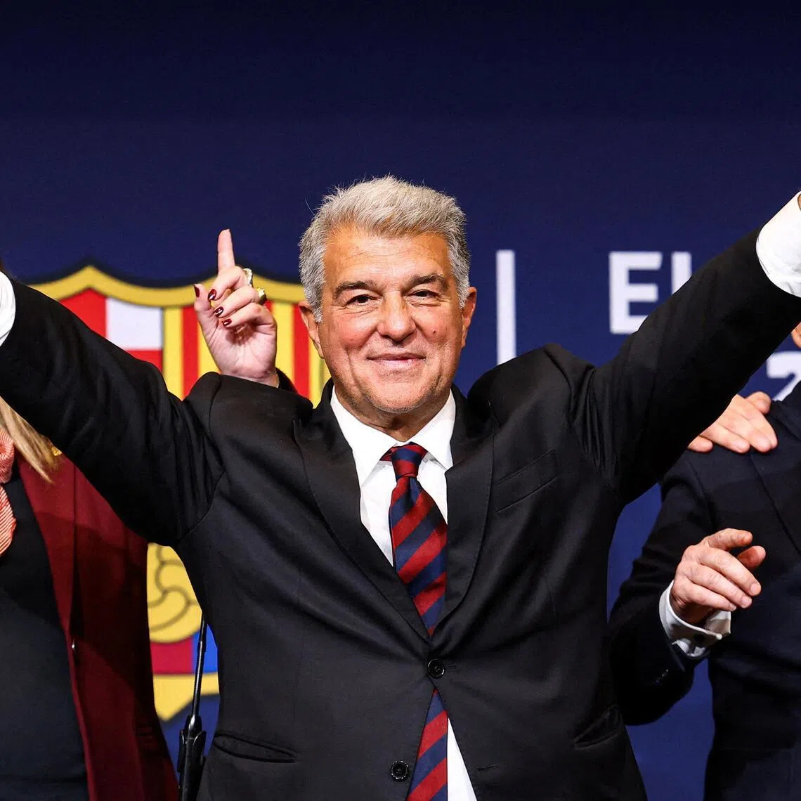Joan Laporta celebrates his victory after being re-elected as Barcelona president alongside his board members.