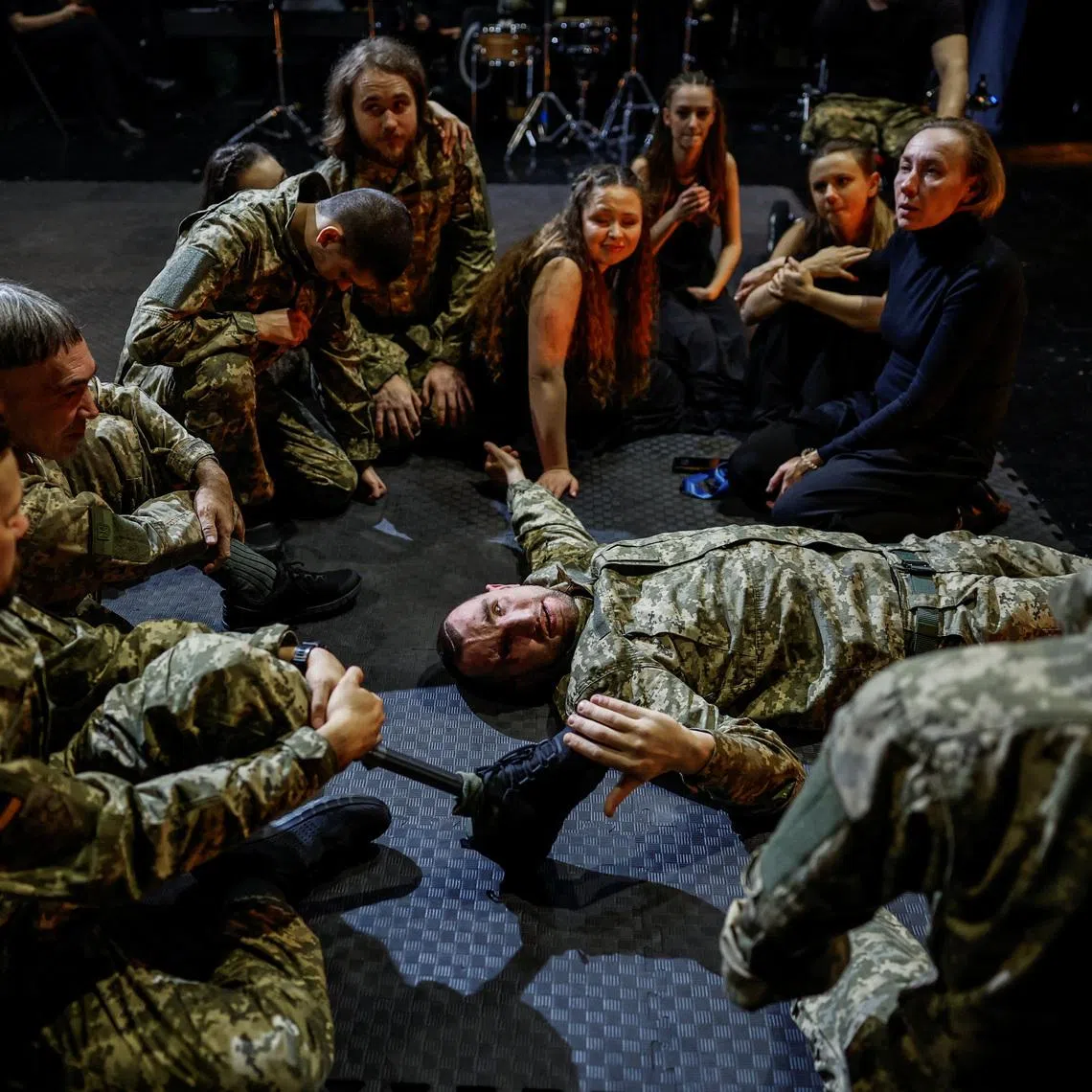 Olha Semoshkina (top right), chief choreographer of the Veterans' Theatre group, talks to the actors before the premiere of an 18th‑century Ukrainian parody of Virgil's \"Aeneid\", amid Russia's attack on Ukraine, in Kyiv, Ukraine, December 4, 2025. Fellow member and veterans' psychologist Yehor Babenko, 27, said the transformative trauma of serious injury often compels people to seek meaning in something new. He said it was critical for his fellow comrades to understand that life does not simply end after a serious injury. \"Sometimes, you understand it’s the opposite - that it just starts getting going.\" REUTERS/Alina Smutko