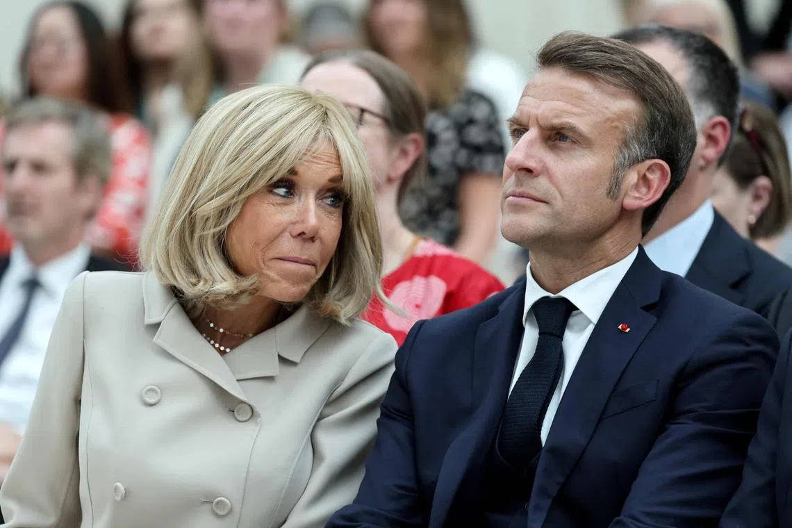TOPSHOT - France's President Emmanuel Macron and his wife Brigitte Macron attend a ceremony during their visit to The British Museum in London on July 9, 2025, during the second day of a three-day state visit to Britain. (Photo by Ludovic MARIN / POOL / AFP)