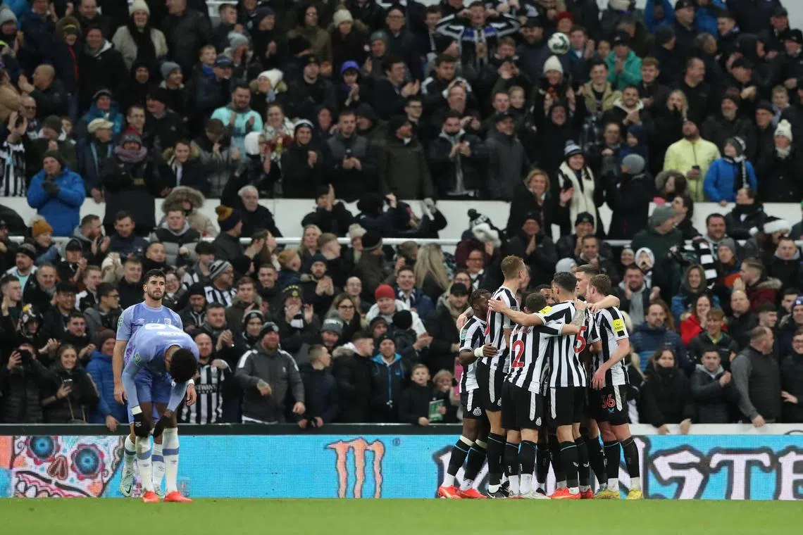 Newcastle United players celebrate Bournemouth's Adam Smith scores an own goal in their 1-0 League Cup fourth-round win.