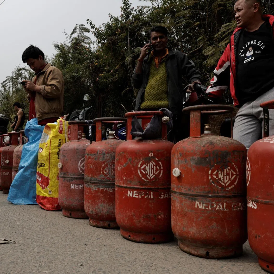 People stand in a queue with their empty LPG cylinders outside a depot of Nepal Gas Industries Pvt. Ltd. amid the U.S.-Israeli conflict with Iran, in Kathmandu, Nepal, March 12, 2026. REUTERS/Navesh Chitrakar