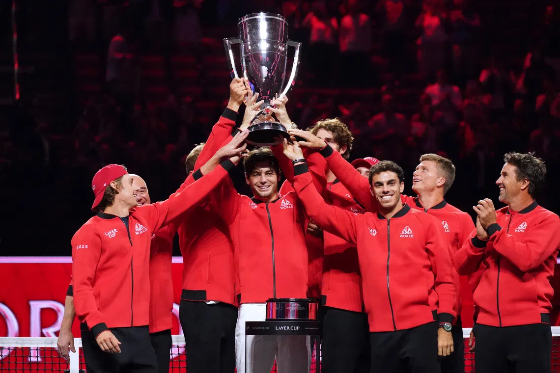 Sep 21, 2025; San Francisco, CA, USA; Team World player Taylor Fritz hoists the trophy with teammates after defeating Team Europe during the Laver Cup at Chase Center. Mandatory Credit: David Gonzales-Imagn Images