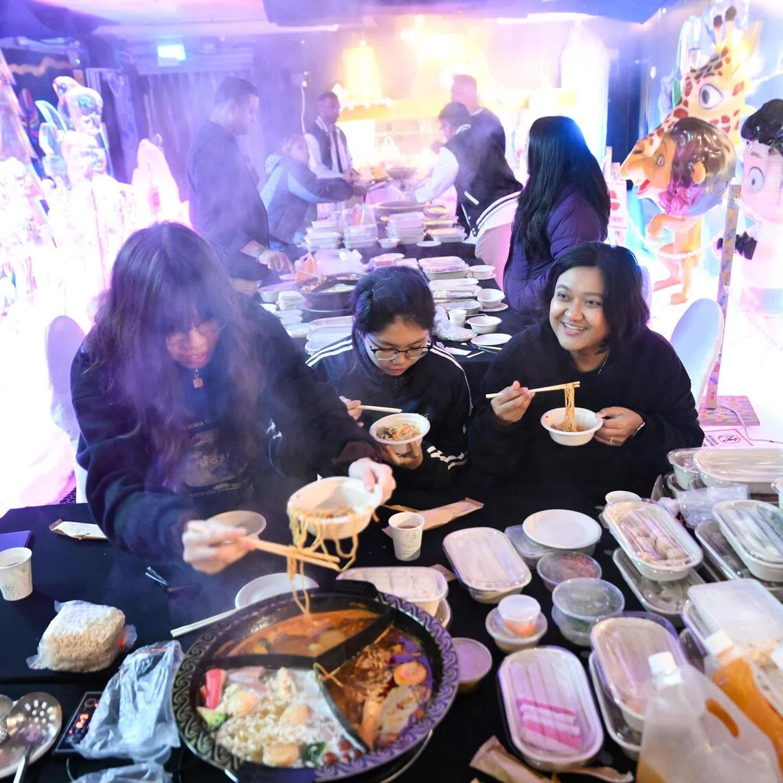 Snow City and Pictureworks staff enjoying hotpot in the snow chamber after it closed its shutters for good at 6.49pm on Sept 30.