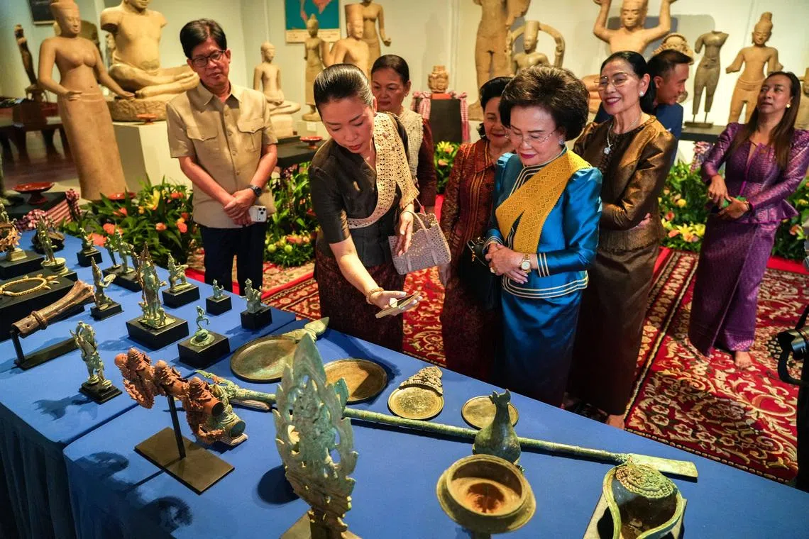 People attend a ceremony for the return of 74 Khmer cultural objects to Cambodia.
