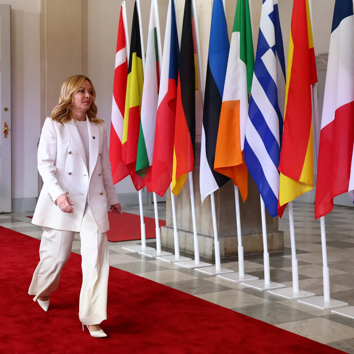 Italy's Prime Minister Giorgia Meloni walks as she is welcomed by Denmark's Prime Minister Mette Frederiksen (not pictured) on the day of the informal meeting of European Union leaders in Copenhagen, Denmark, October 1, 2025. REUTERS/Piroschka van de Wouw