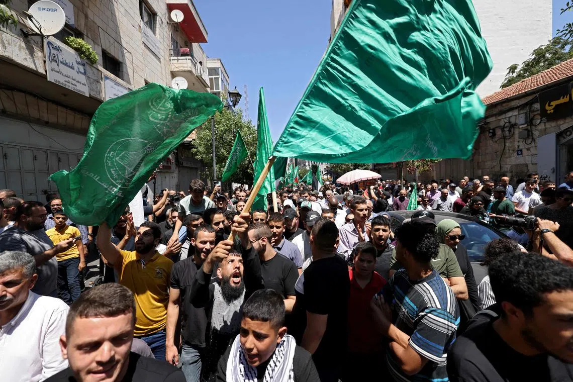 Palestinians shout slogans during a protest in the streets of the Israeli-occupied West Bank city of Ramallah on July 31, 2024, following the news of the assassination of the political chief of the Palestinian Hamas militant group in Iran. 