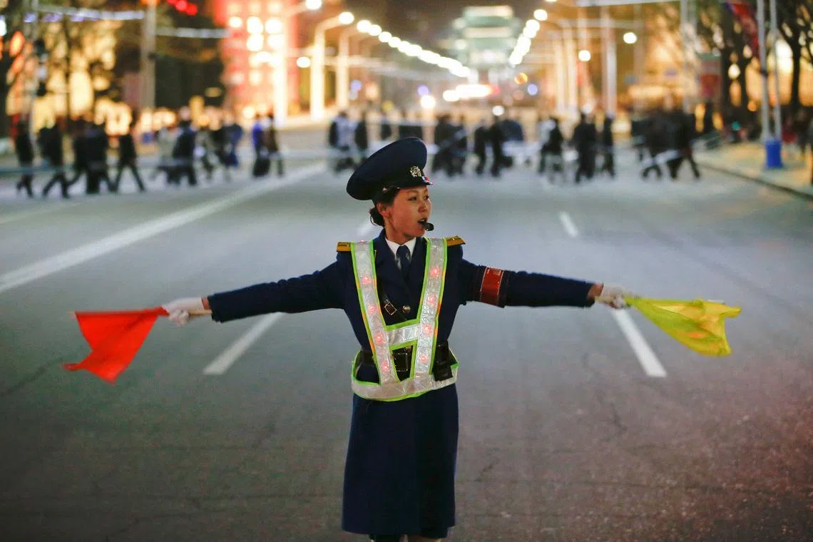 A policewoman controls the traffic as people gather near the main Kim Il Sung square in central Pyongyang, North Korea April 11, 2017.  REUTERS/Damir Sagolj/File Photo