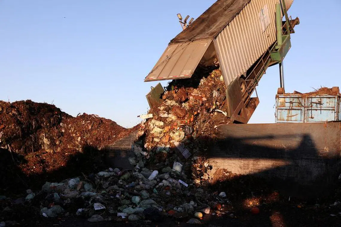 FILE PHOTO: A large truck container dumps food scraps collected from the city of San Francisco into the presorting area before being processed at Recology Blossom Valley Organics North near Vernalis, California, U.S., November 10, 2022.  REUTERS/Brittany Hosea-Small/File Photo