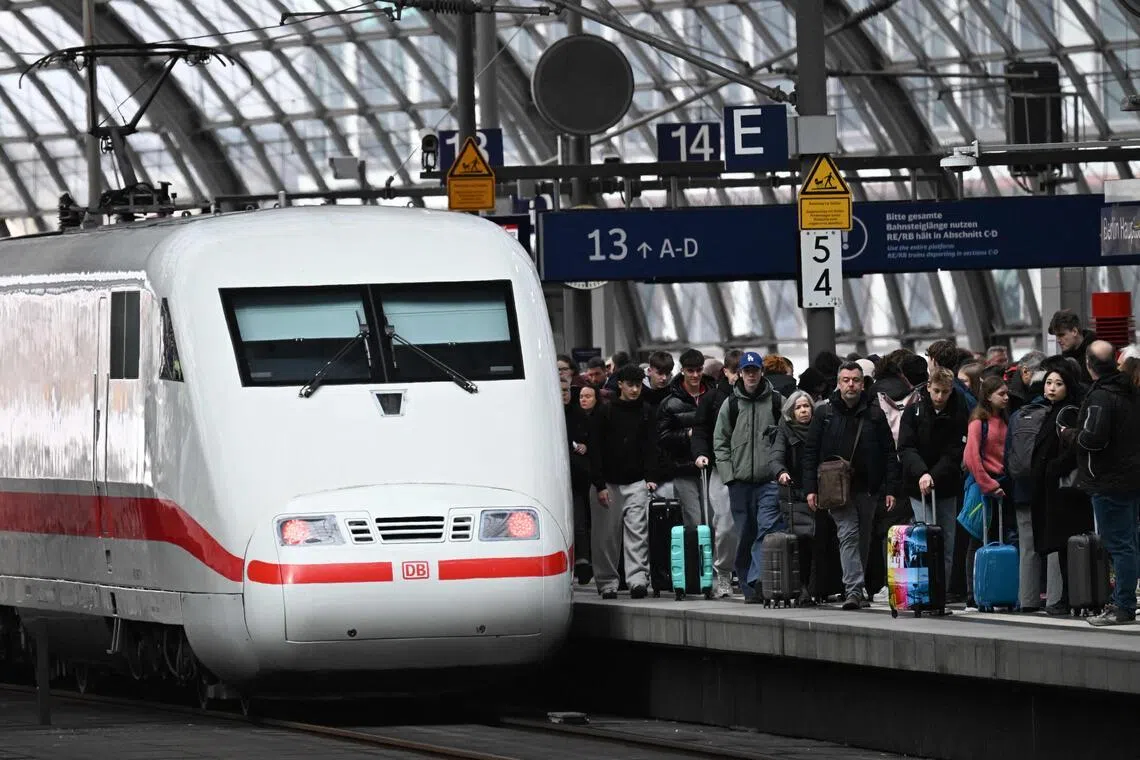 An ICE (Inter City Express) train by German railway operator Deutsche Bahn (DB) is pictured on March 27, 2026 at the main train station in Berlin. (Photo by RALF HIRSCHBERGER / AFP)