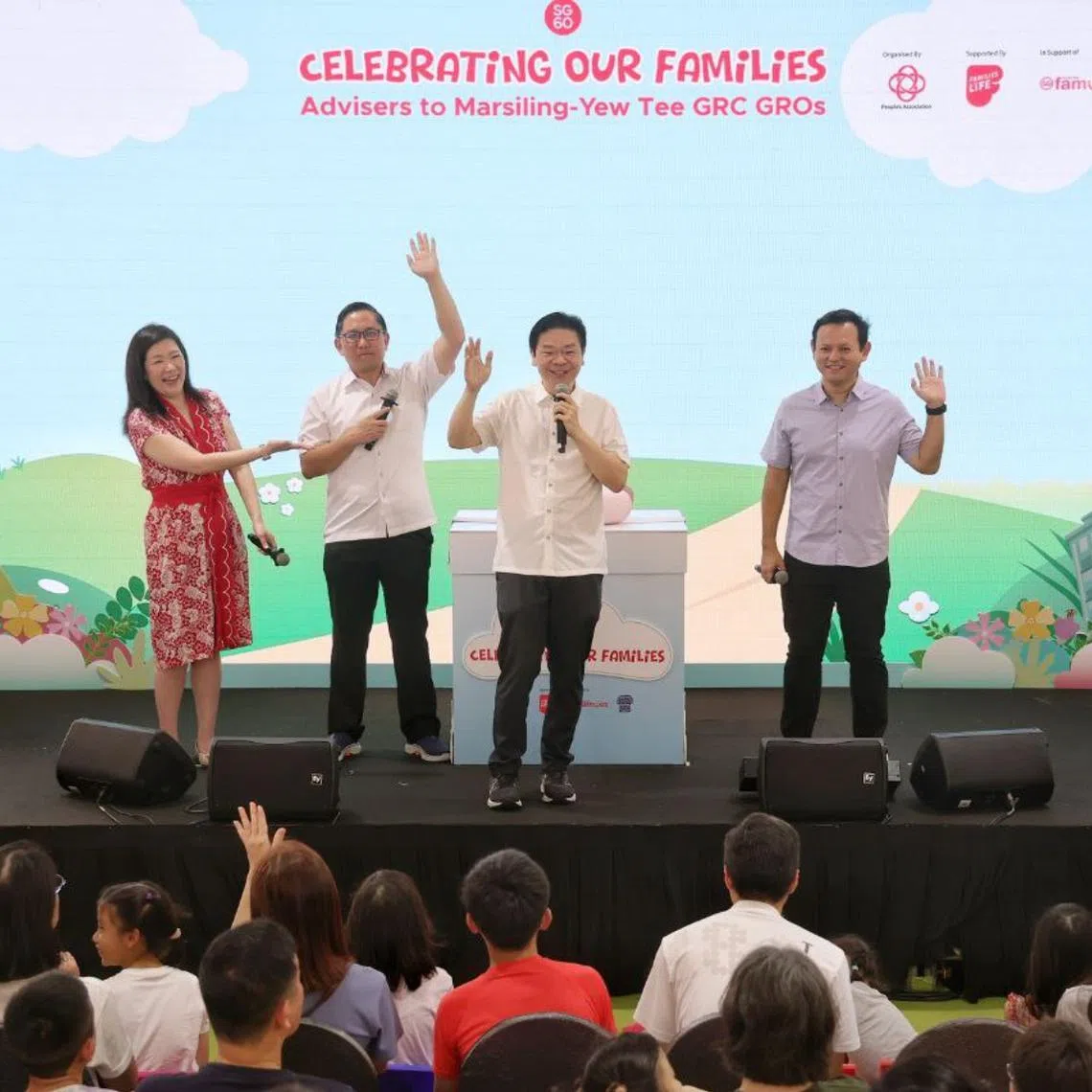 (From left) Ms Hany Soh, North West District Mayor Alex Yam, Prime Minister Lawrence Wong and Senior Minister of State for Manpower Zaqy Mohamad addressing residents during the launch of the distribution of the SG60 Baby Gift at Celebrating Our Families – MY Family Carnival 2025 at the hard court beside Yew Tee MRT station on April 12. 