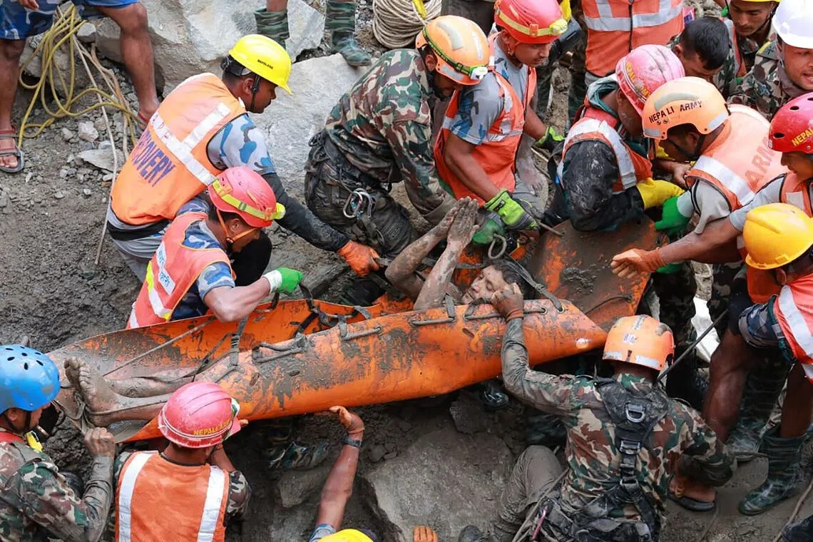 TOPSHOT - This handout photograph taken and released by the Nepal Army on September 4, 2026 shows army personnel carrying a worker who was trapped inside a tunnel, during a rescue operation at Trishuli-3A Hydropower Project in Nepal's Rasuwa district. Two hydropower workers were pulled from a tunnel buried by debris in Nepal on September 4, more than a week after catastrophic flooding swept through the area, government ministers said. (Photo by Handout / NEPAL ARMY / AFP) / RESTRICTED TO EDITORIAL USE - MANDATORY CREDIT "AFP PHOTO/Nepal Army/HANDOUT" - NO MARKETING NO ADVERTISING CAMPAIGNS - DISTRIBUTED AS A SERVICE TO CLIENTS