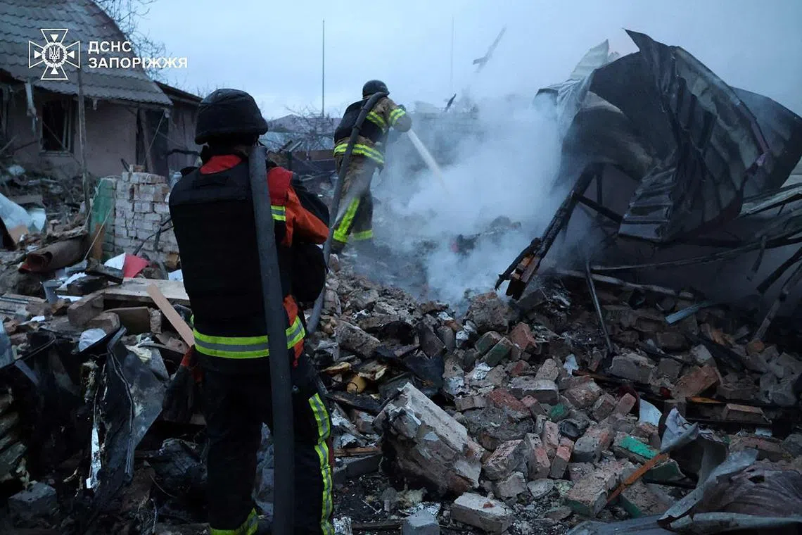 Firefighters working to put out a blaze in Ukraine's Zaporizhzhia region on March 31, following an aerial guided bomb attack by Russia.