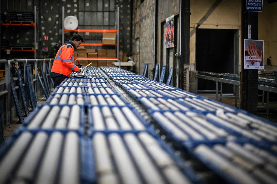 An employee works on a mining core line at the lithium plant of French multinational industrial minerals company Imerys in Echassierres, central France, on January 17, 2024. Minerals group Imerys has undertaken the Emili project, aimed at extracting lithium at its Beauvoir site to help Europe limit its dependence on China. Scientists consider the Massif Central's lithium potential to be "more than respectable", but mining projects are a source of both economic hope and environmental concern. (Photo by OLIVIER CHASSIGNOLE / AFP)