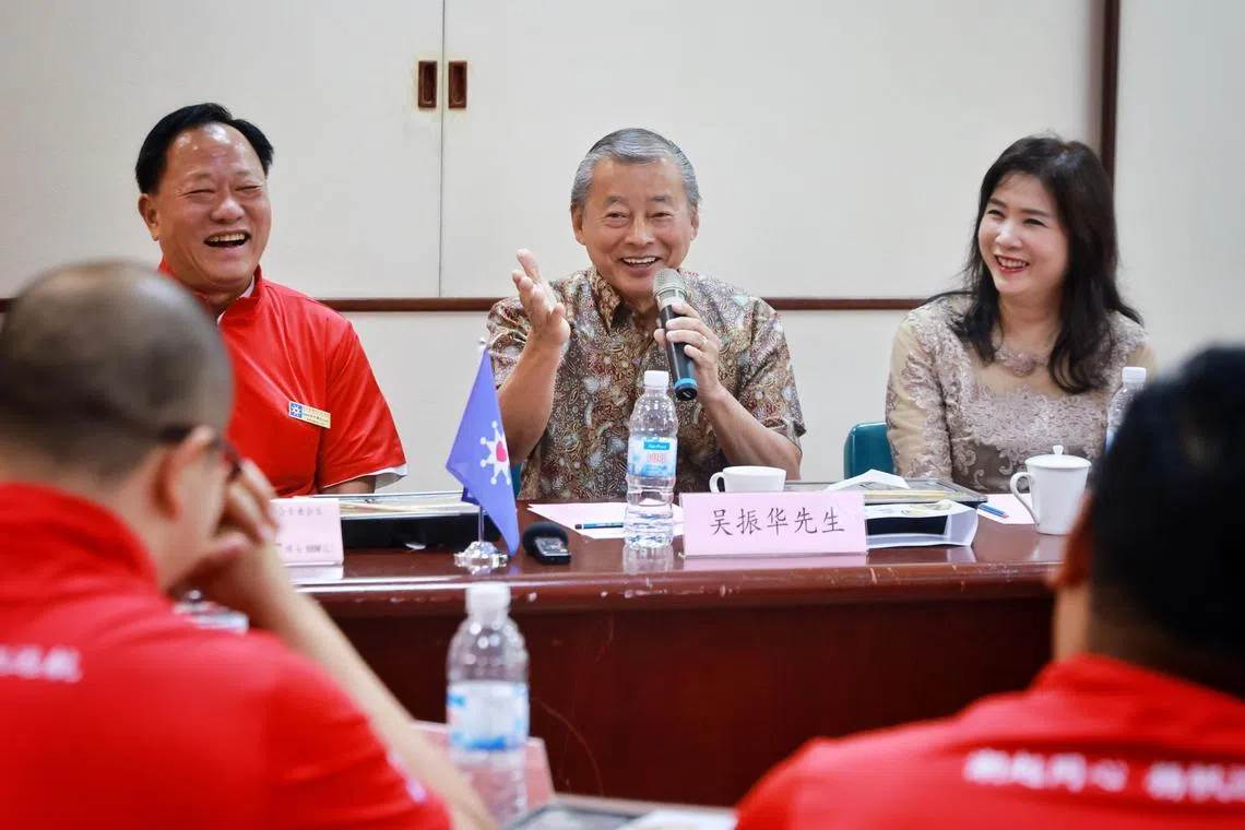 Presidential hopeful George Goh, accompanied by his wife Lysa Sumali (right) and clan association's president Derek Goh, speaking to the media after a visit to Teochew Poit Ip Huay Kuan's premises on Aug 15.