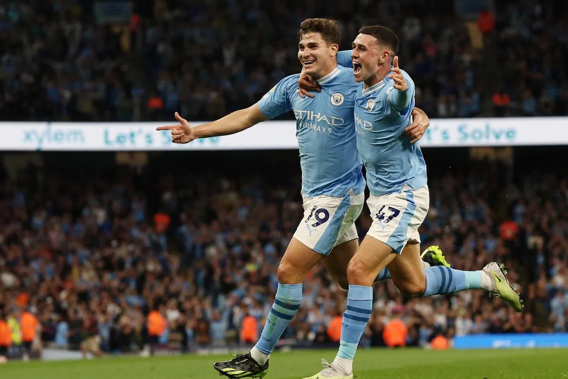 Manchester City's Julian Alvarez (left) celebrates his goal with teammate Phil Foden.