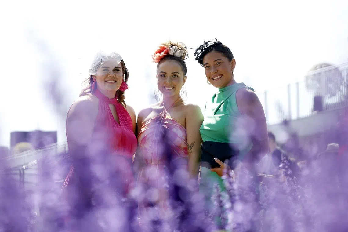 Racegoers posing for photographs on Melbourne Cup Day at Flemington Racecourse in Melbourne, Australia on Nov 7, 2023.  