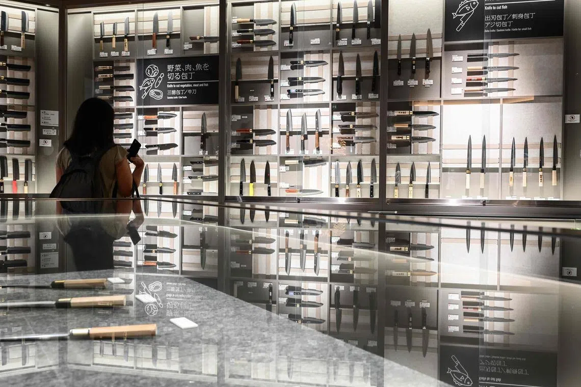 A visitor looking at a display of knives at the Sakai Traditional Crafts Museum during a government-sponsored tour of the city of Sakai, Osaka prefecture ahead of the G7 Trade Ministers' Meeting at the end of October. The port at Sakai has a long history, with international trade dating back to the 16th century. As a trading hub, combined with a longer history of blacksmiths, the city's economy expanded due to the exchange of goods from overseas. The production of knives, as well as firearms, and centuries later bicycles, all flourished due to the rich history of traditional metal processing techniques. Nowadays, Japanese knives are popular among aspiring and professional chefs, who prize their delicate precision, sleek finish and long lifespan. (Photo by Richard A. Brooks / AFP)