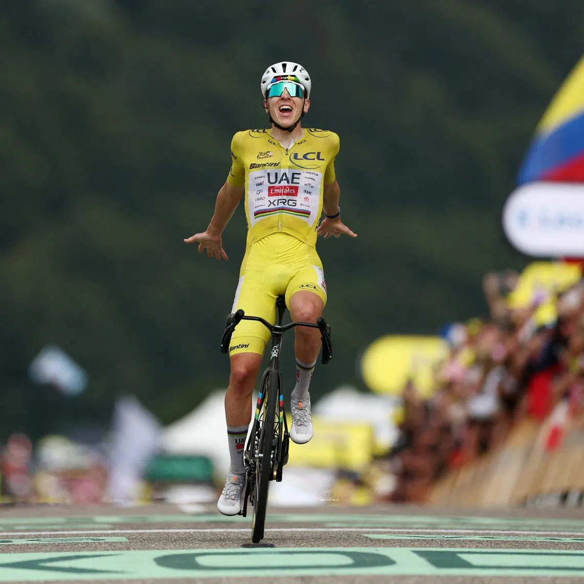 UAE Team Emirates XRG’s Tadej Pogacar, wearing the yellow jersey, celebrates after winning Stage 14 of the Tour de France on July 18.