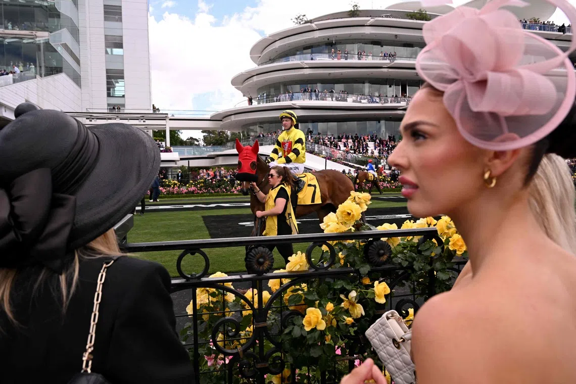 People watching the horses before the start of the Melbourne Cup horse race at the Flemington Racecourse in Melbourne on Nov 4, 2025. 