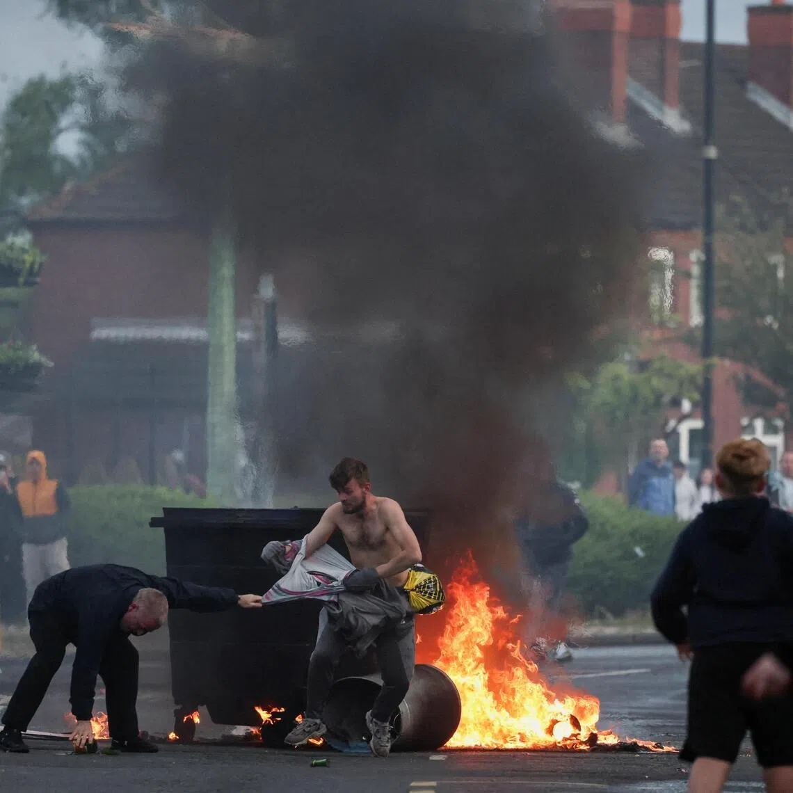 A fire burns during a protest on June 9 after a knife attack left a man seriously injured in Belfast, Northern Ireland.