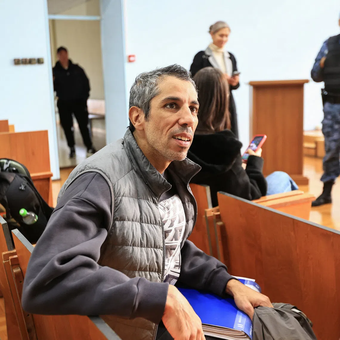 French cyclist Sofiane Sehili, who was found guilty of illegally crossing the Russian border while attempting to break the world record for the fastest cycle crossing of the Eurasian landmass and freed by a court that ordered him to pay a fine, sits in a courtroom in the far eastern settlement of Pogranichniy, Russia, October 23, 2025. REUTERS/Tatiana Meel