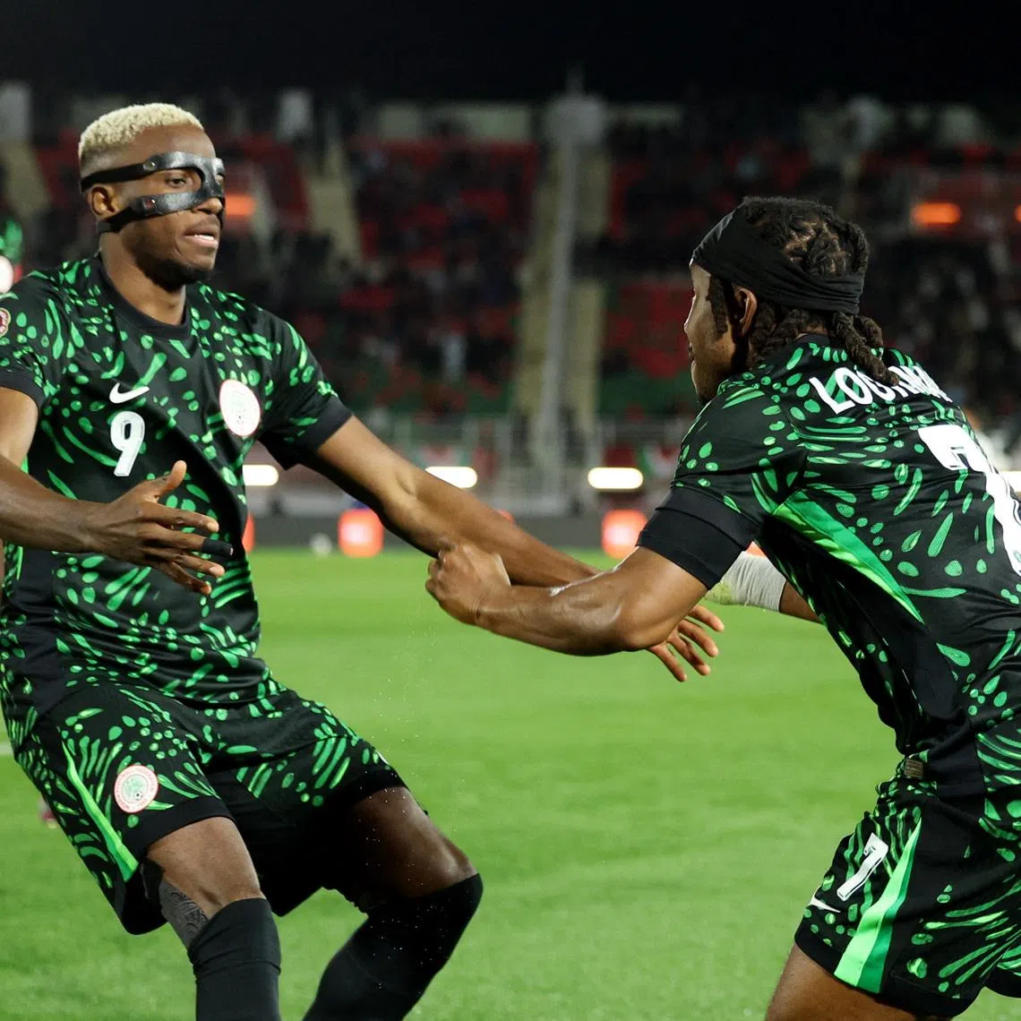 Soccer Football - CAF Africa Cup of Nations - Morocco 2025 - Round of 16 - Nigeria v Mozambique - Fez Stadium, Fes, Morocco - January 5, 2026 Nigeria's Victor Osimhen celebrates scoring their third goal with Ademola Lookman REUTERS/Amr Abdallah Dalsh