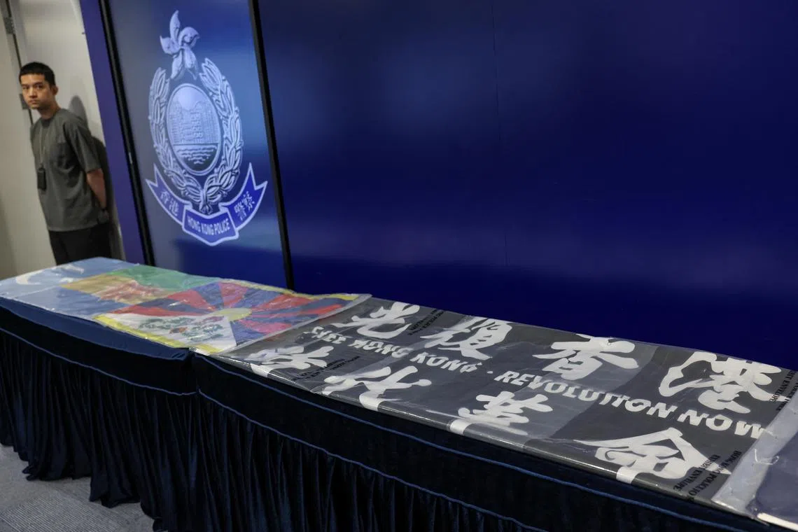 A flag with the slogan "Liberate Hong Kong, the revolution of our times" and a Tibetan flag at a police press conference regarding an arrest operation in Hong Kong on July 10.