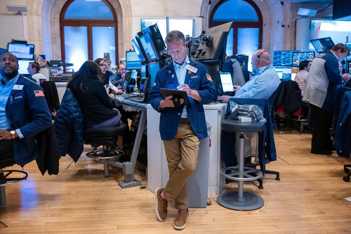 Traders work on the floor of the New York Stock Exchange, in New York City.
