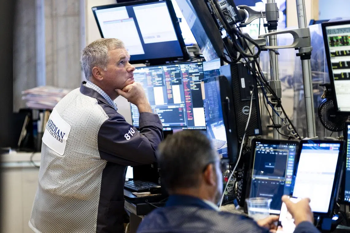 Traders working on the floor of the New York Stock Exchange at the opening bell on July 16.