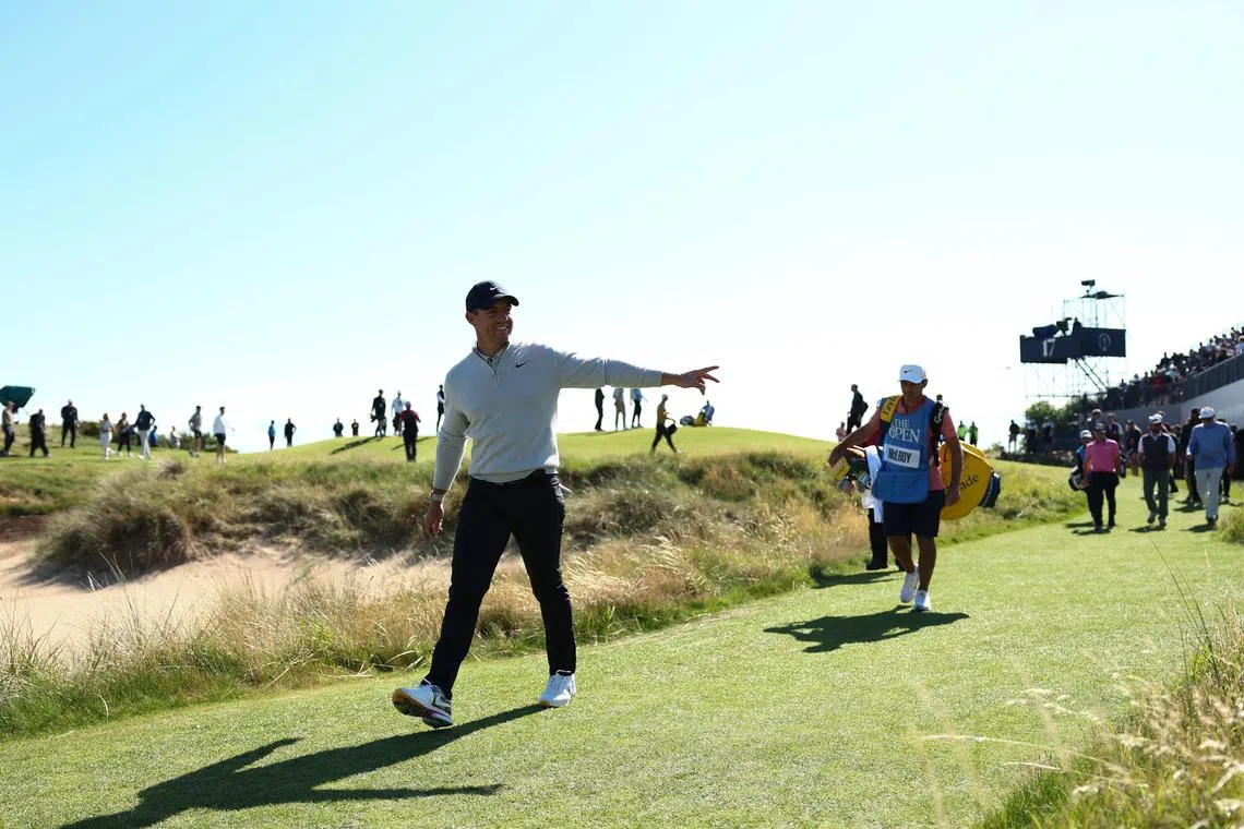 Northern Ireland's Rory McIlroy waves to the crowd during practice day ahead of the British Open, in Hoylake, Britain.