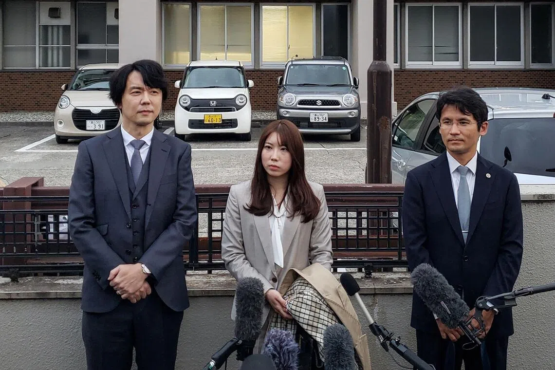 Ms Riho Fukuyama (centre) and her husband Yoshiki Fukuyama (left) speak to the media with their lawyer (right) outside the Toyama District Court in Toyama city on Oct 21, 2025. 