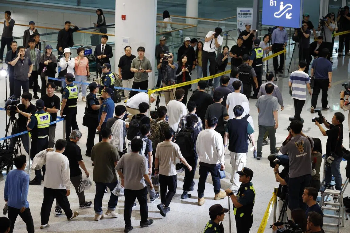 South Korean workers detained in a US Immigration and Customs Enforcement raid at a Georgia factory arrive at Incheon International Airport in Incheon, South Korea, on Sept 12, 2025.