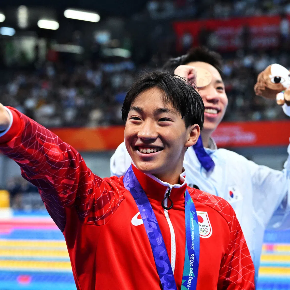 Japan’s Shin Ohashi celebrating after winning the men’s 200m breaststroke in a world record at the Tokyo Aquatics Centre in the Aichi-Nagoya Asian Games on Sept 24.
