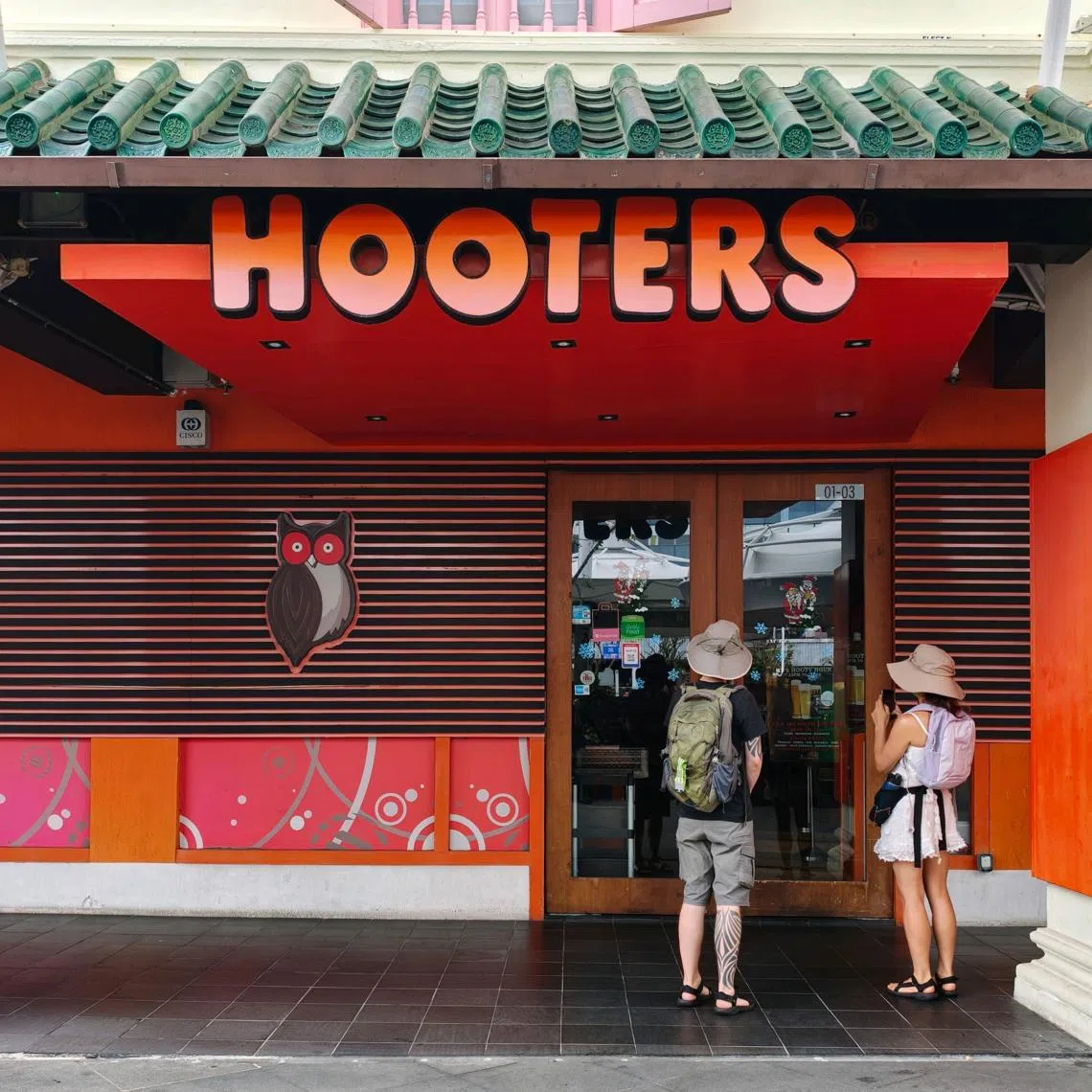 Curious onlookers waiting for the Hooters outlet at Clarke Quay to open on Dec 29. There was no signage of the impending closure.