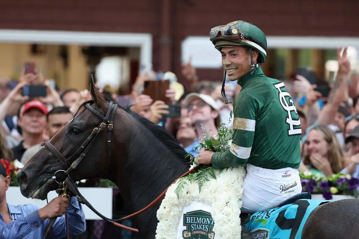 SARATOGA SPRINGS, NEW YORK - JUNE 06: Jose Ortiz atop Golden Tempo celebrates winning the 158th running of the Belmont Stakes at Saratoga Race Course on June 06, 2026 in Saratoga Springs, New York.   Al Bello/Getty Images/AFP (Photo by AL BELLO / GETTY IMAGES NORTH AMERICA / Getty Images via AFP)