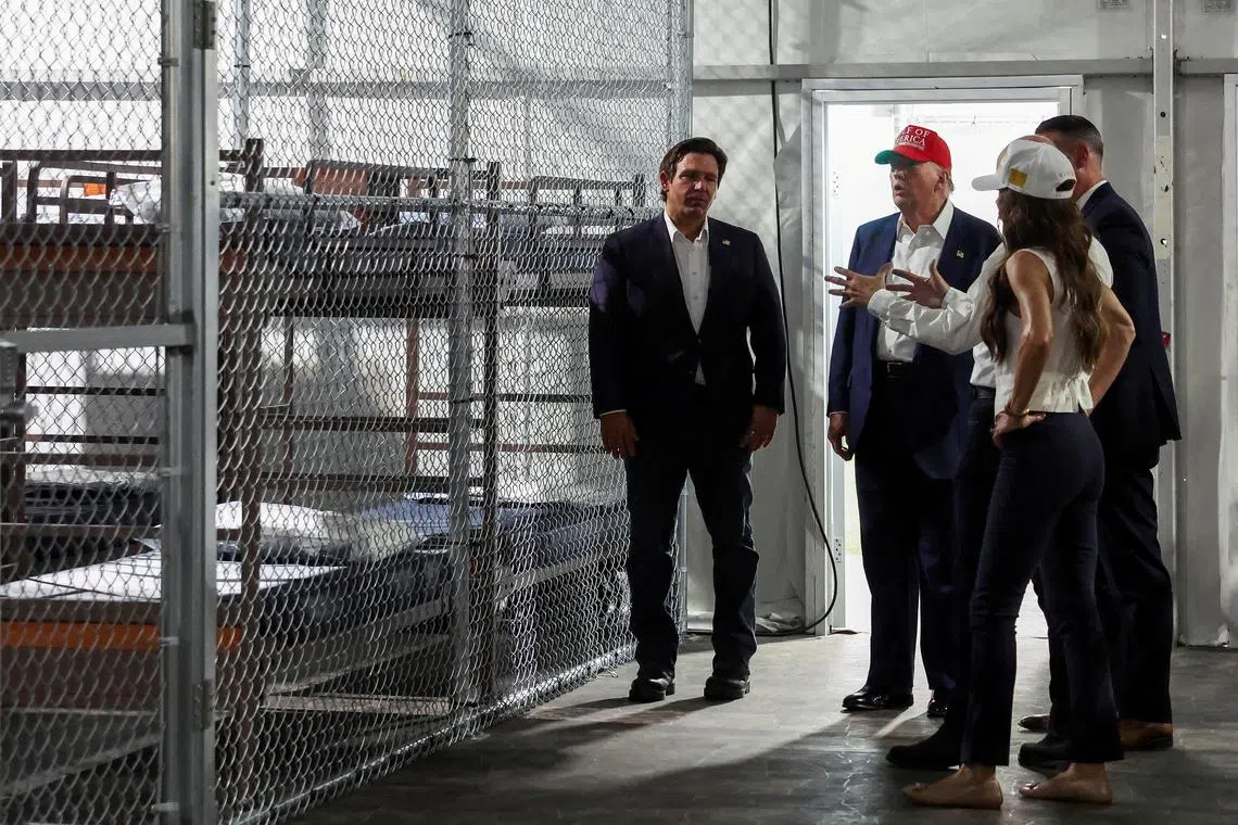 FILE PHOTO: U.S. President Donald Trump, Florida Governor Ron DeSantis and U.S. Homeland Security Secretary Kristi Noem visit a temporary migrant detention center informally known as \"Alligator Alcatraz\" in Ochopee, Florida, U.S., July 1, 2025. REUTERS/Evelyn Hockstein/File Photo