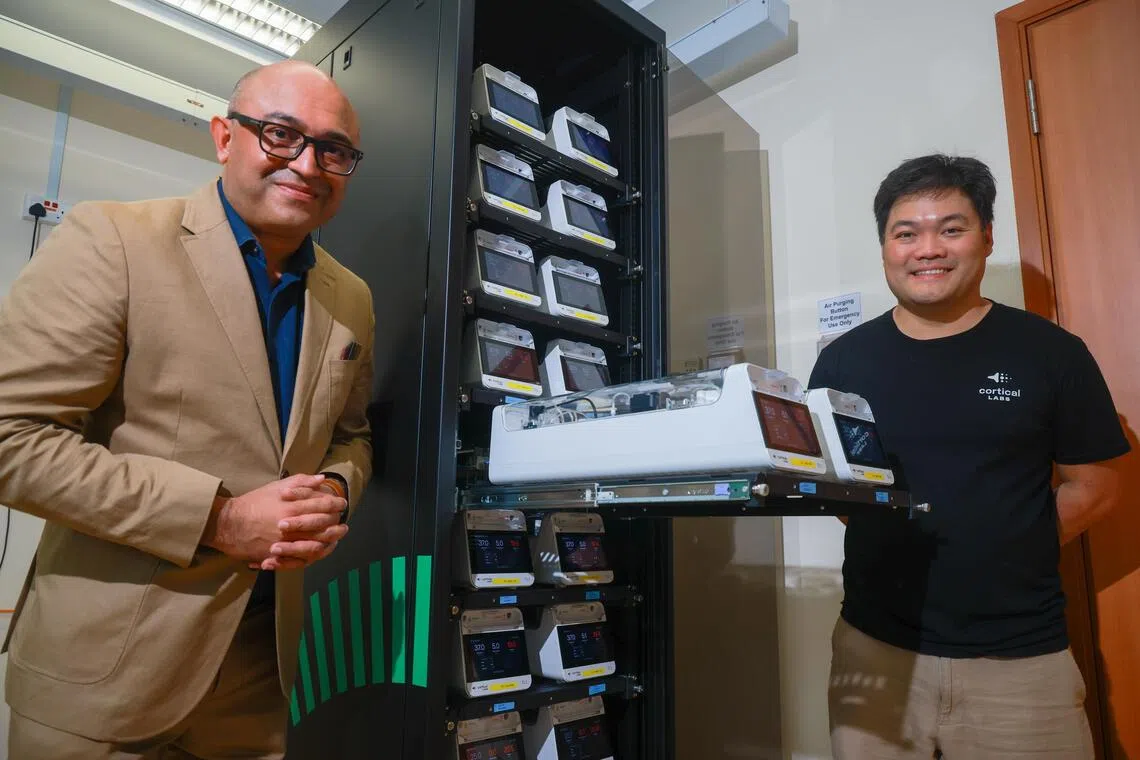Prof Rickie Patani (left) and Hon Weng Chong, Founder and CEO of Cortical Labs, at the brain-cell powered data centre at NUS on Aug 7.
