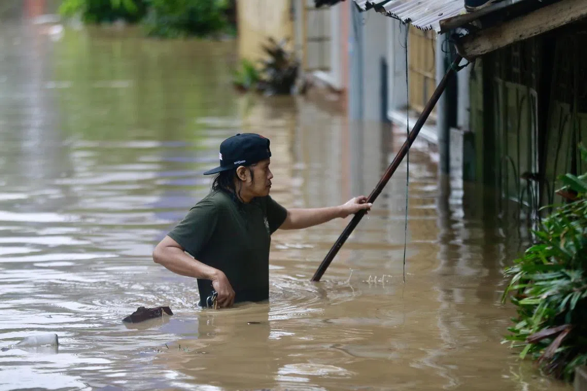 A villager wades in the flood-hit town of Pagsanjan, south of Manila. 