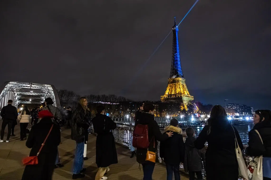 Paris' Eiffel Tower was swathed in blue and yellow light shortly after sundown in the French capital.