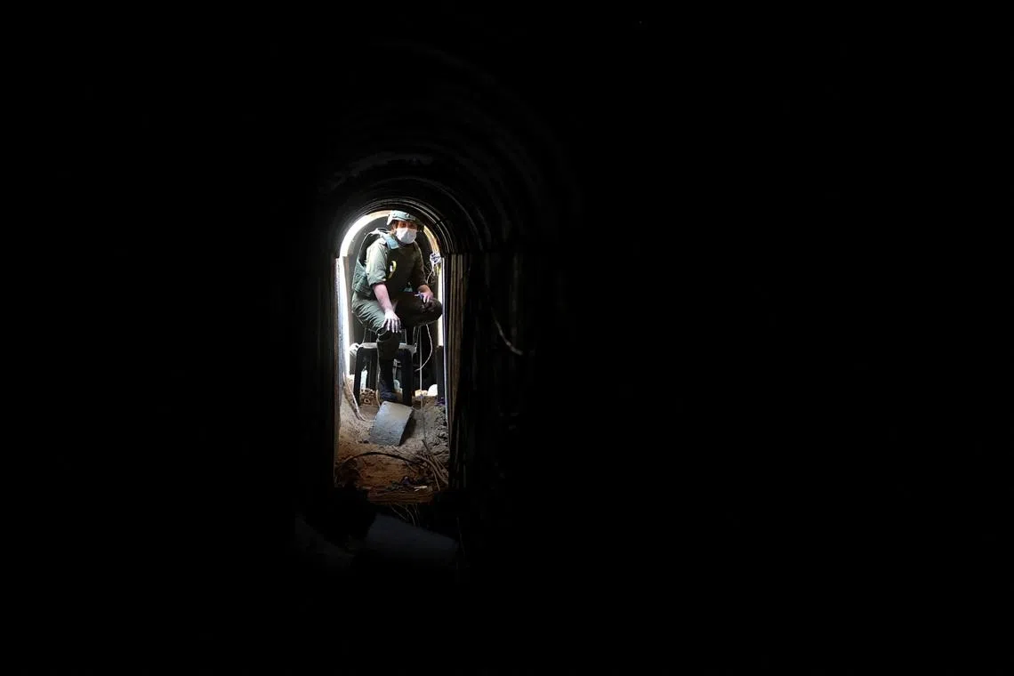 An Israeli soldier sits inside a tunnel underneath the European Hospital in Khan Younis at the Gaza Strip, amid the ongoing ground operation of the Israeli army against Palestinian Islamist group Hamas, June 8, 2025. REUTERS/Ronen Zvulun