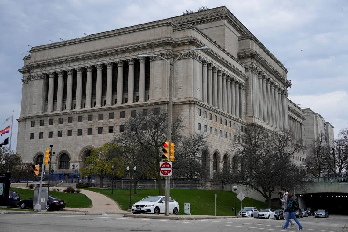 FILE PHOTO: People walk outside Milwaukee County Courthouse, after Wisconsin county judge Hannah Dugan was arrested by U.S. officials, charging her with helping a man in her court evade immigration authorities in an escalating dispute between President Donald Trump's administration and local officials over immigration enforcement, in Milwaukee, Wisconsin, U.S., April 25, 2025.  REUTERS/Vincent Alban/File Photo