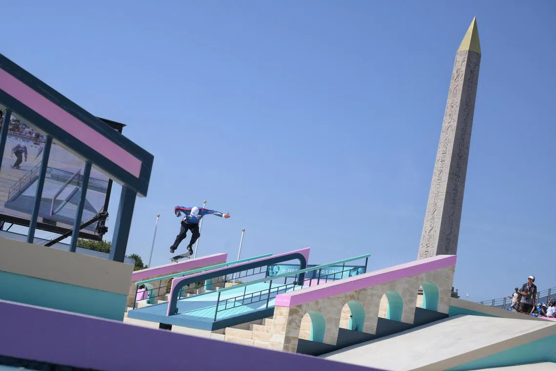 The Luxor Obelisk on the Place de la Concorde is seen as a skateboarder grinds down a rail during the men’s skateboarding street prelims of the Paris Olympics.