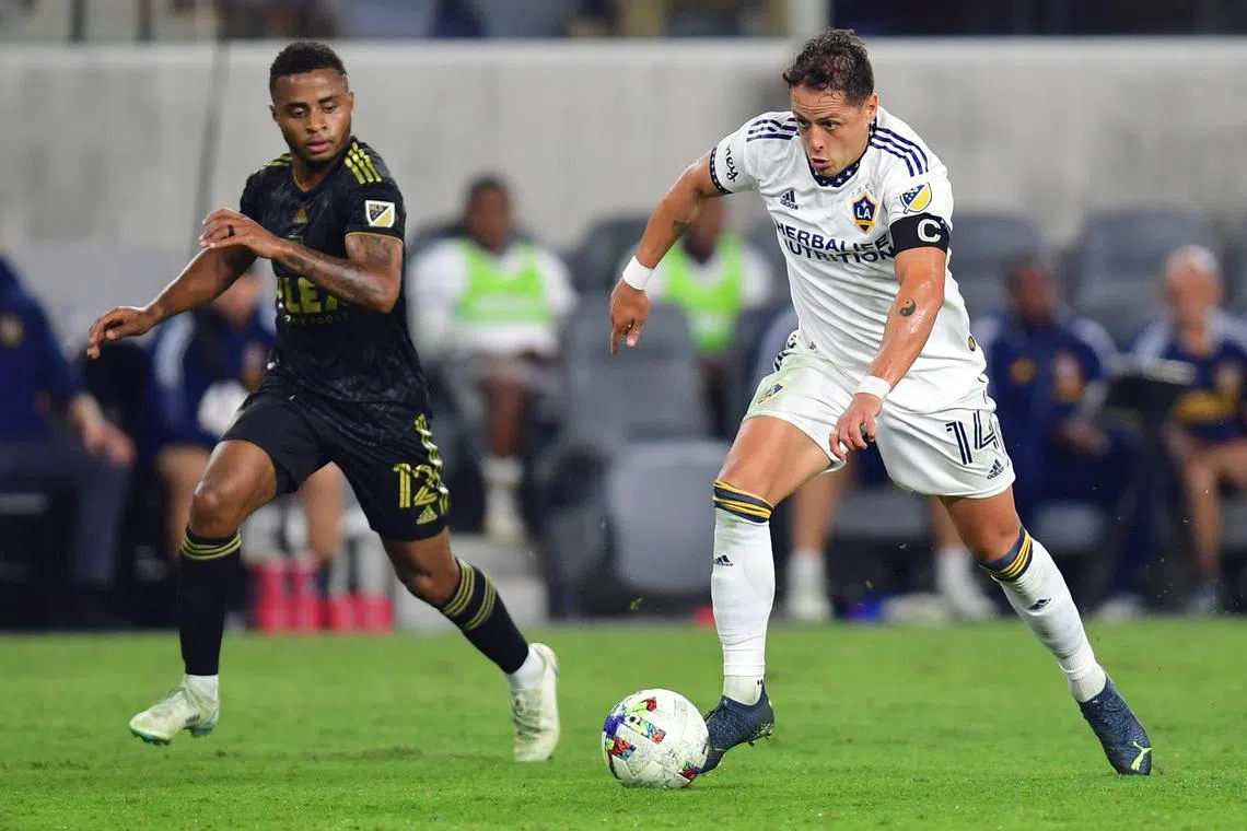 Los Angeles Galaxy forward Javier Hernandez dribbles past Los Angeles FC defender Diego Palacios during their MLS Cup play-off semi-final in October 2022.