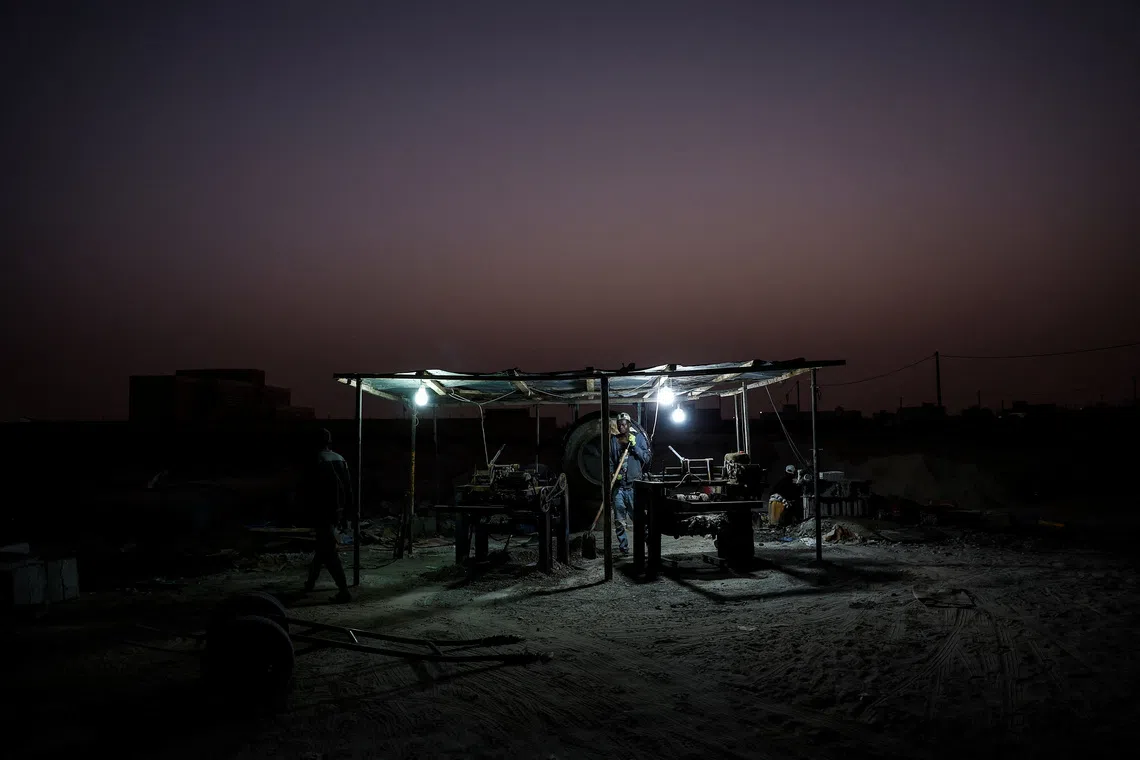 Maka Keila, 27, and Garry Ndajy, 32, work at an open-air brick workshop, on the outskirts of Nouakchott, Mauritania, February 22, 2025, amid a crackdown on irregular migration following a 2024 partnership agreement with the European Union. \"I know a lot of people who go to Nouadibou (a northern port in Mauritania),\" Keila said. \"There are a lot of friends there, who were looking to get to Europe. They say that now everything has stopped.\"  REUTERS/Juan Medina
