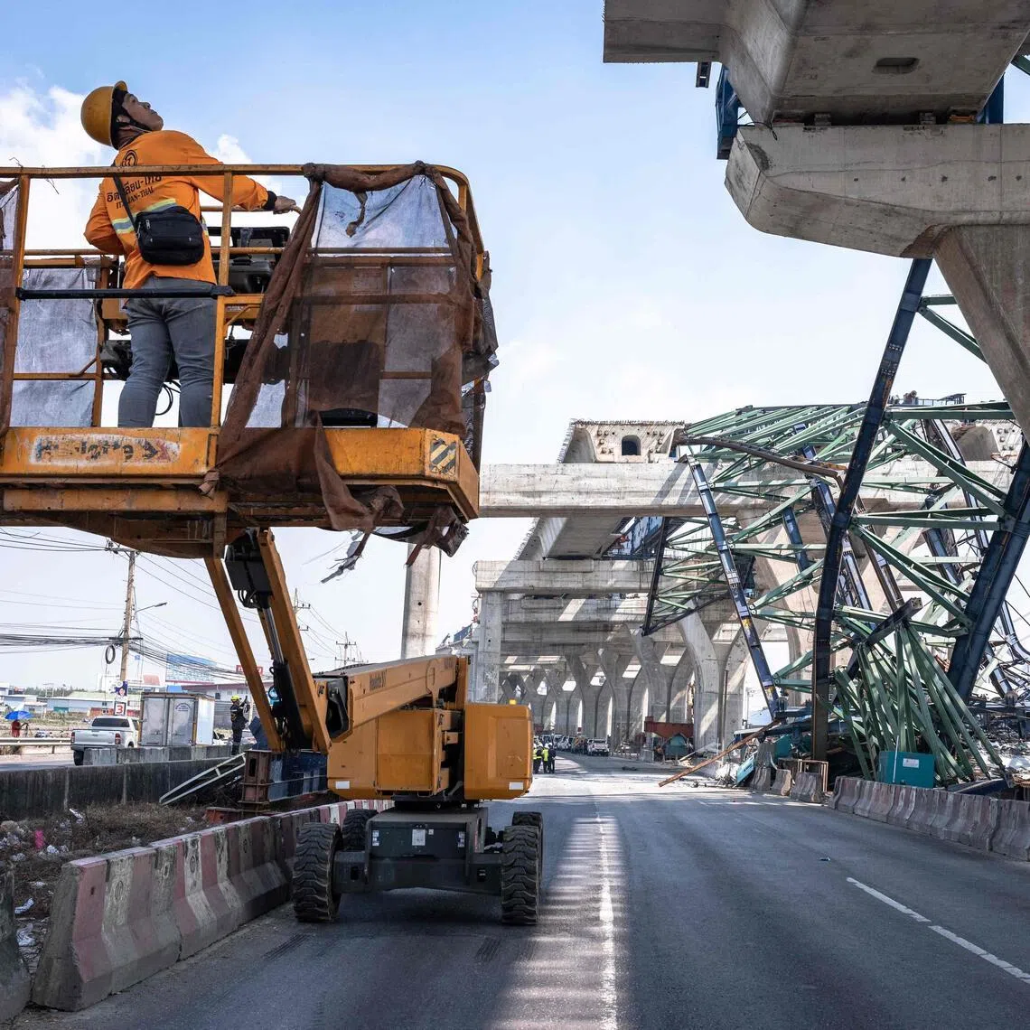 A recovery worker uses a cherry picker near the site of a construction crane collapse in Samut Sakhon on the outskirts of Bangkok on Jan 15.