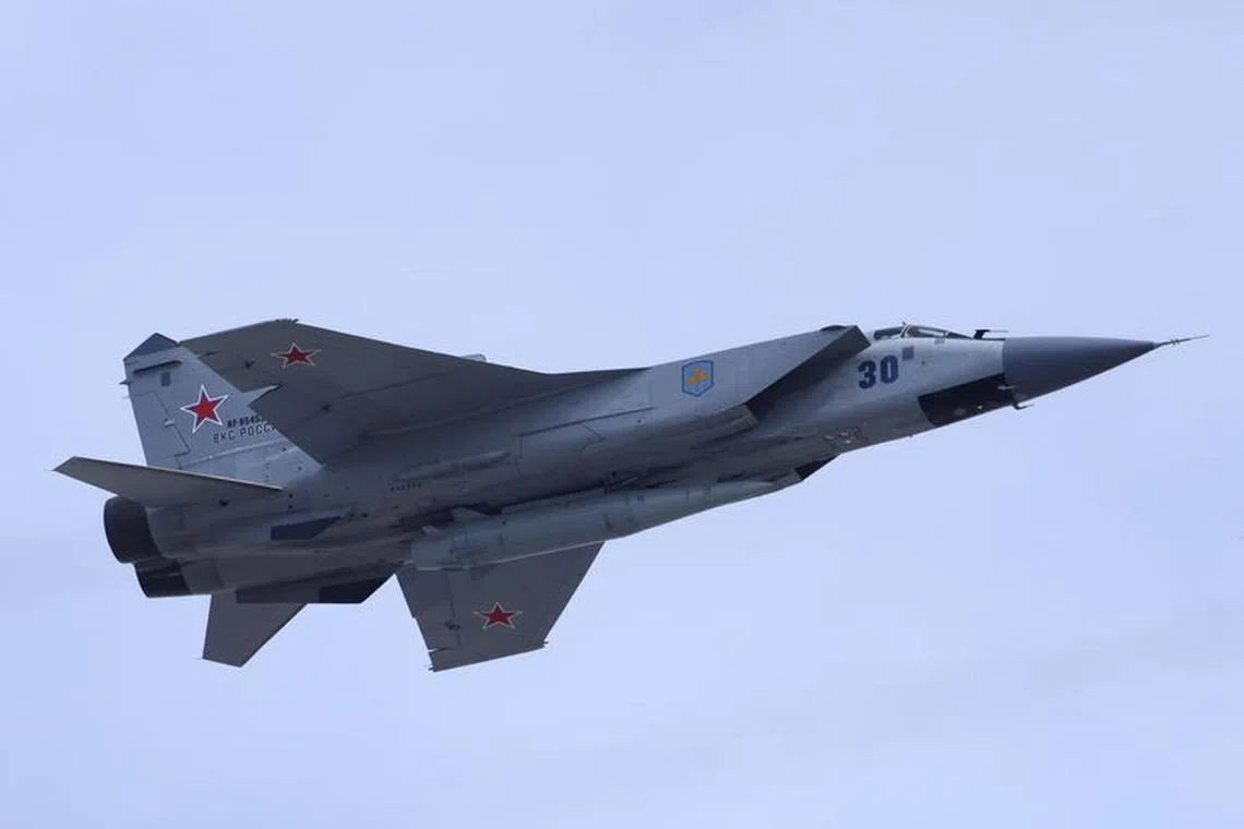A Russian MiG-31 fighter jet equipped with a Kinzhal hypersonic missile flies over Red Square during a rehearsal for a flypast, part of a military parade marking the anniversary of the victory over Nazi Germany in World War Two, in central Moscow, Russia May 7, 2022. REUTERS/Maxim Shemetov/file photo