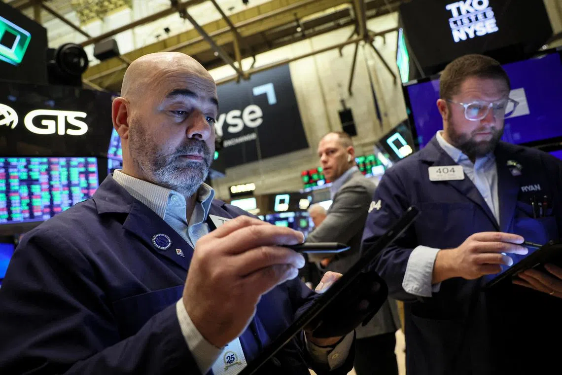 Traders work on the floor at the New York Stock Exchange, in New York City.